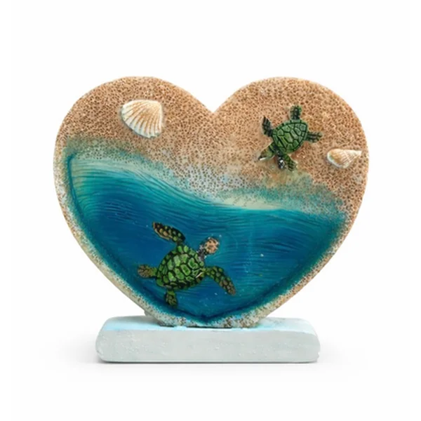 Heart-shaped resin seaside magnet with two sea turtles in blue water and sand, with shells, on a stand
