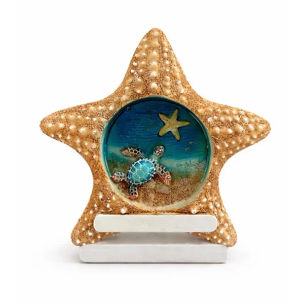 Starfish-shaped resin frame magnet with a sea turtle on a sandy beach scene, on a white stand
