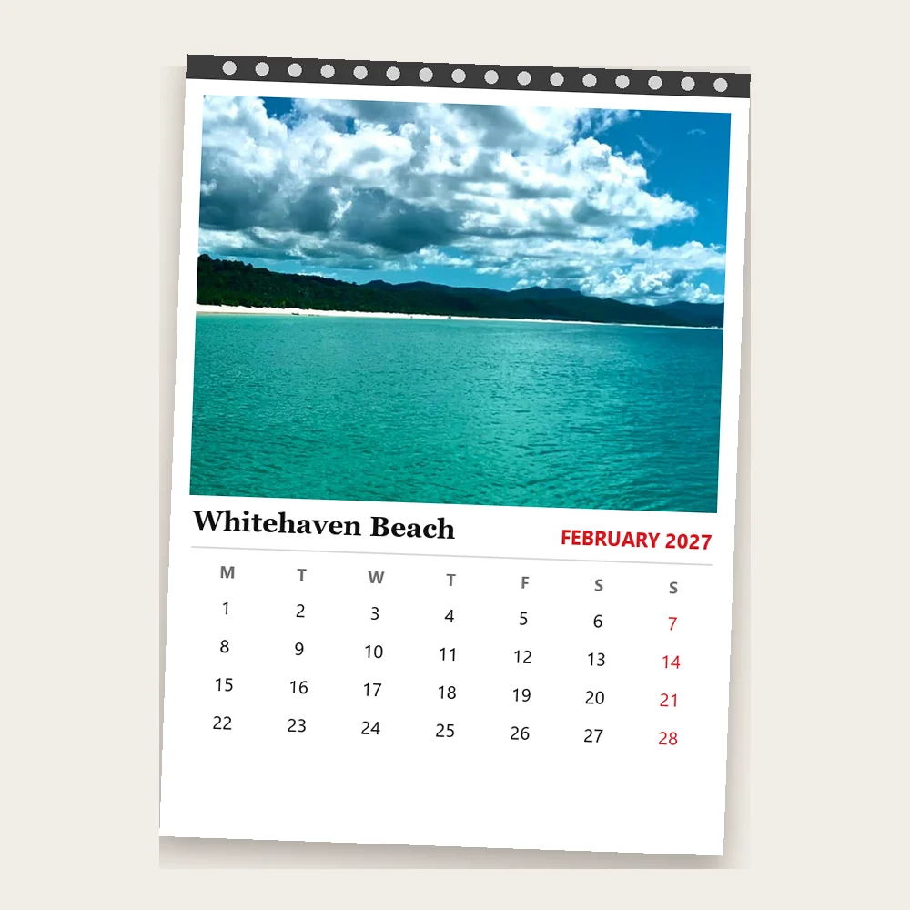 Wall calendar page with a photo of Whitehaven Beach above a February calendar grid